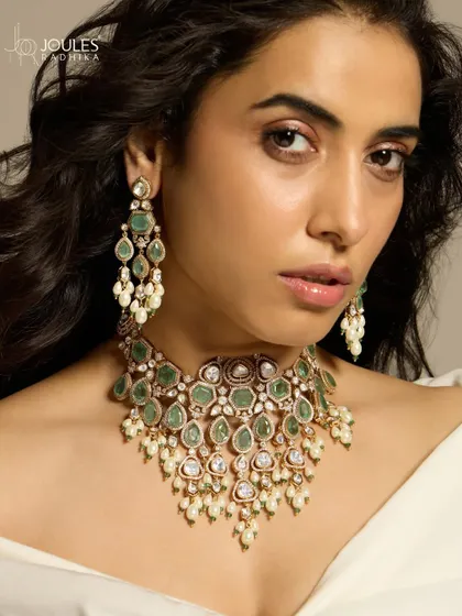 A royal and unforgettable bridal set worn by Nimrit Ahluwalia, featuring cascading emeralds and polki diamonds that create a truly show-stopping look.