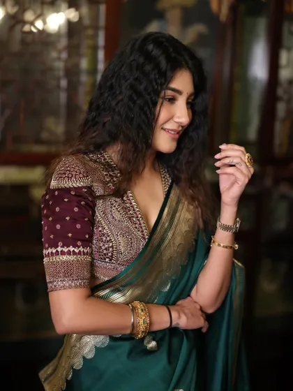 Another shot of the green saree look, showing how the rich fabric and gold border drape beautifully.