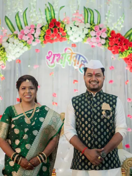 A formal portrait of the newly engaged couple, Rohan and Pradnya, standing before the 'Shubh Vivah' backdrop.