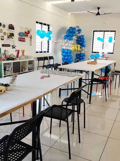 The studio is decorated with blue and white balloons for a special birthday celebration. We love creating a festive atmosphere for your child's art party.