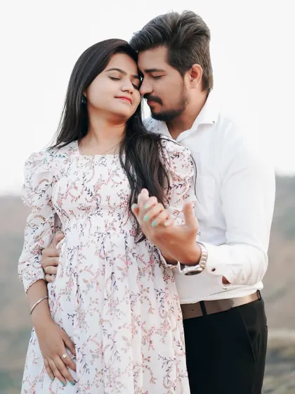A gentle, loving pose that shows their deep affection. The soft focus on the background keeps the attention on the couple.