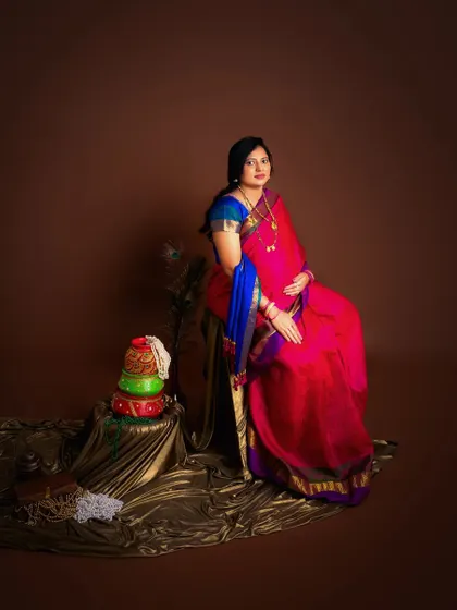 To a forever of elegance. A beautiful portrait of an expecting mother in a vibrant pink and blue saree, celebrating the life she is about to bring into the world.