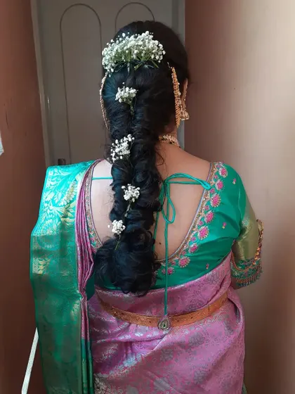 Another view of the messy braid with baby's breath, showing the texture and volume.