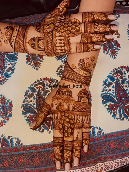 A beautiful back-hand design with peacocks perched on top of royal architecture.