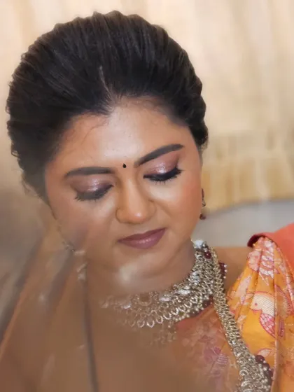 A close-up of this bride's soft and romantic eye makeup. The champagne shimmer on the lids adds a touch of modern elegance to her traditional look.