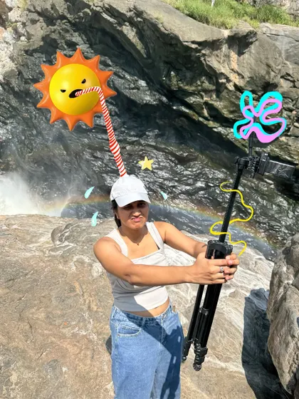 A fun photo with a tripod at a waterfall, made even more goofy with a sun doodle drinking from a straw.