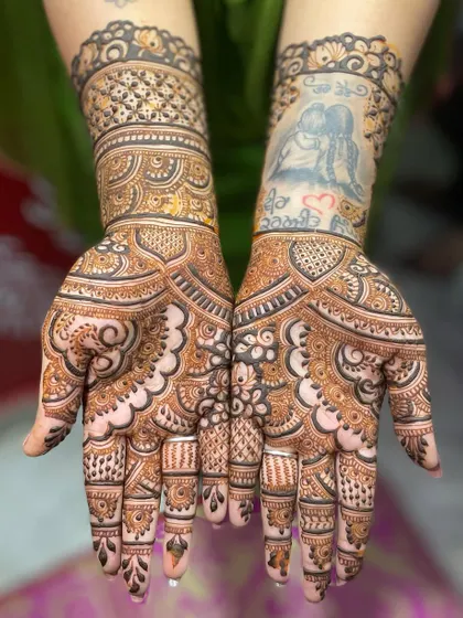 This design shows how you can incorporate a tattoo into your mehendi. I created a window in the pattern to showcase the existing art on the wrist.