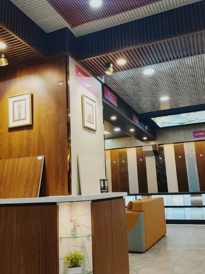 A view of our reception desk and the adjacent wall, which is clad in beautiful wood-finish panels.