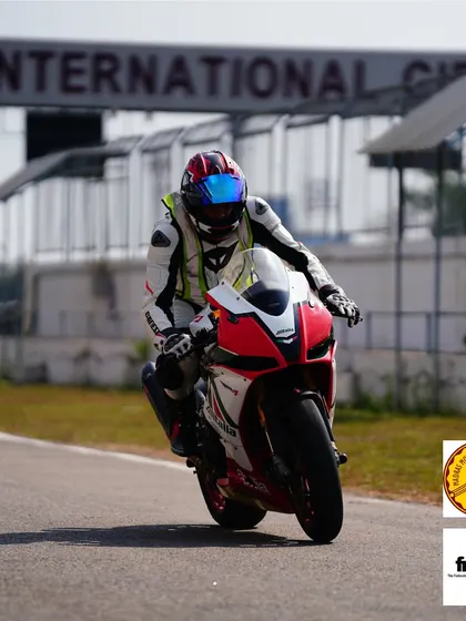 A rider in zen mode on an Aprilia, cruising down the pit lane exit. The moment of calm before you unleash the power on the main straight.