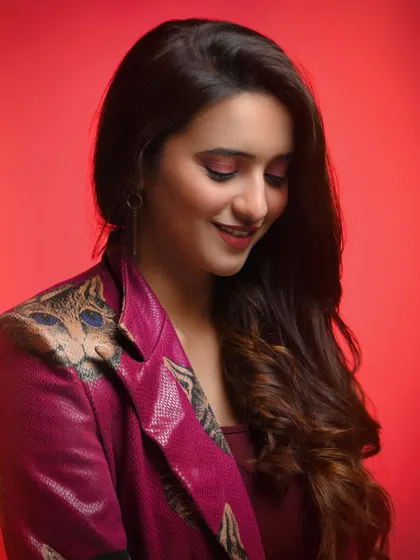 Even within a moody setup, we can capture moments of warmth. The soft smile and downward gaze create a sweet, candid-feeling moment, adding another layer of personality to her portfolio.