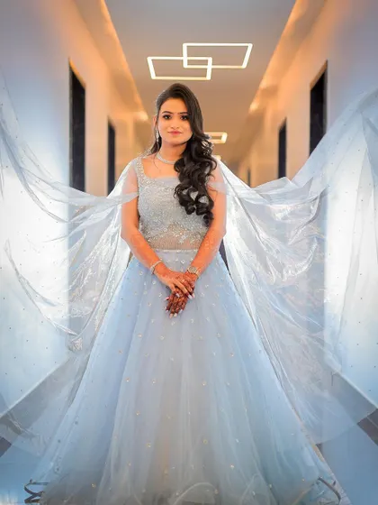 A creative shot using the bride's veil to create a dramatic, wing-like effect.