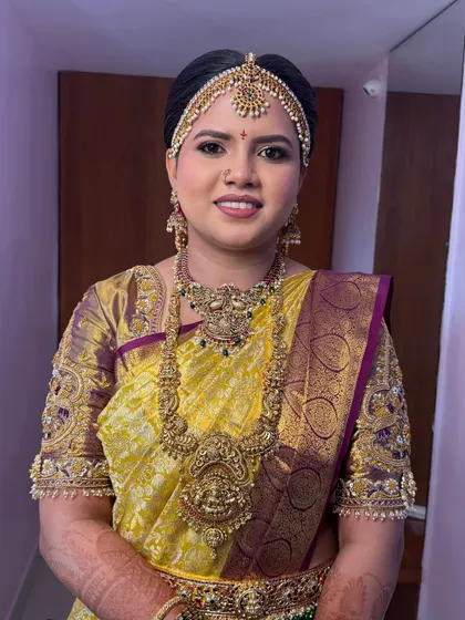 A smiling portrait of the bride-to-be. The makeup is designed to look fresh and happy, capturing the joy of the ceremony.