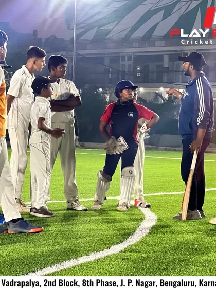 Behind every fearless player is a fearless coach. A coach gives a mid-match briefing to his team on the turf under the lights.
