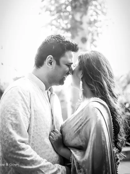 An intimate black and white shot from a Roka ceremony. The couple is nose-to-nose, sharing a private, romantic moment.