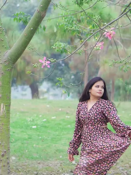 A solo candid shot from a pre-wedding photoshoot, capturing a natural and relaxed portrait in a beautiful outdoor location.