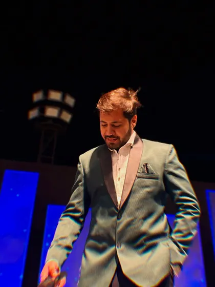 A moment of reflection on stage, getting ready for the next high-energy segment of the night.