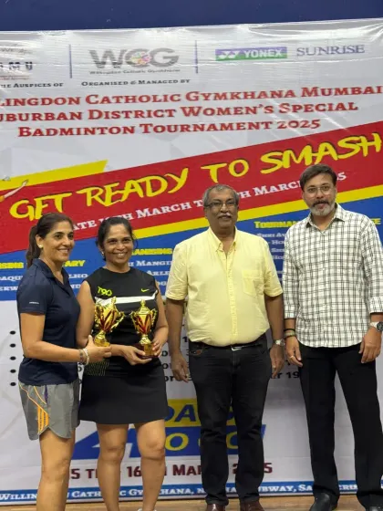Two more skilled players receiving their trophies at the WCG Women's Special Badminton Tournament.