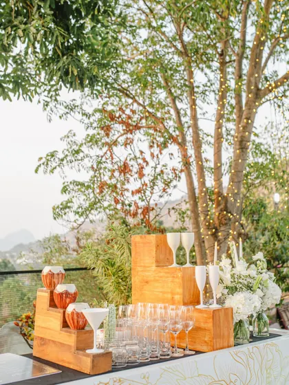 The bar setup for a pre-wedding high tea, offering a selection of refreshing beverages in a beautiful outdoor setting.