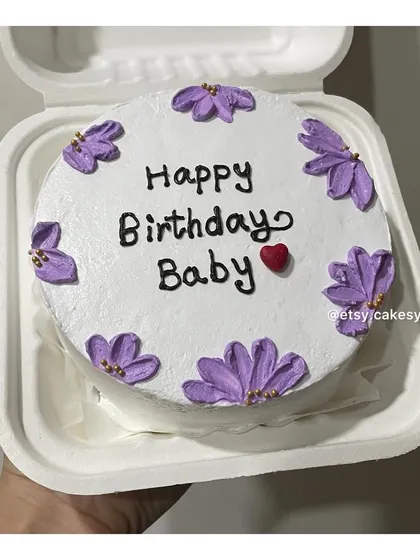 A birthday bento cake decorated with lovely purple flowers.