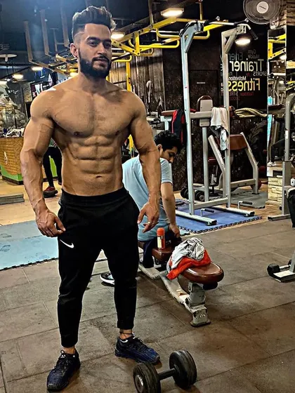 A full-body shot displaying the results of consistent training. My goal is to help you build a balanced, aesthetic, and powerful physique you can be proud of.