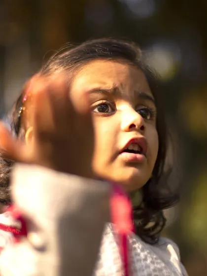 Reaching out with wonder. I love to notice the little things children do, as it shows what inspires them. This candid shot is a beautiful example of a child's natural curiosity.