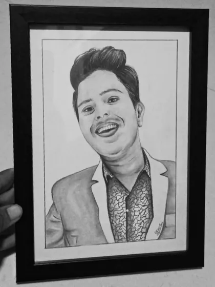 A framed A5 pencil sketch being held up for display. This shows how a smaller, affordable sketch can become a meaningful and high-quality gift.