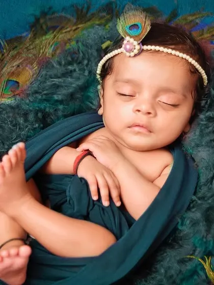 Another beautiful angle from our newborn Krishna session, focusing on the baby's peaceful sleep. We carefully pose little ones to get these timeless, heartwarming images you'll cherish forever.