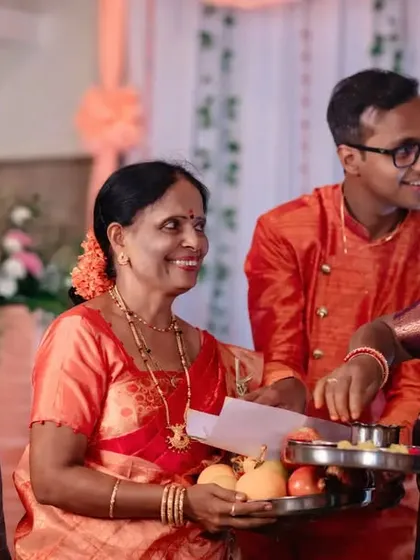 A happy, candid moment from an engagement ceremony, showing the groom interacting with family. We document the joy of your loved ones.