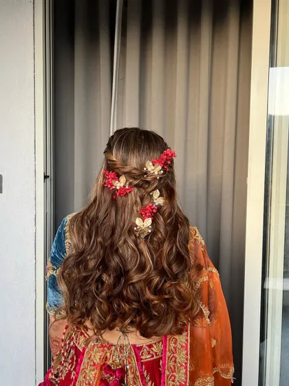 A back view of the enchanting Mehendi hairstyle, showing the intricate details of the braids and accessories.