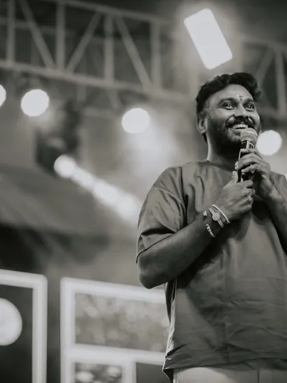A black and white shot capturing a moment of joy while speaking to the audience. Being on stage, connecting with people through dance, is a feeling I cherish.