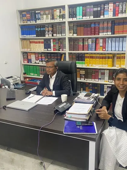 With my colleague in the office, set up for a virtual conference or media interview. Modern legal practice requires adapting to new communication technologies.