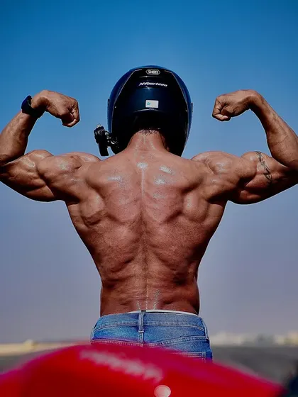 Only my very best will be good enough. This back double biceps pose next to my bike symbolizes the pursuit of excellence in all areas of life.