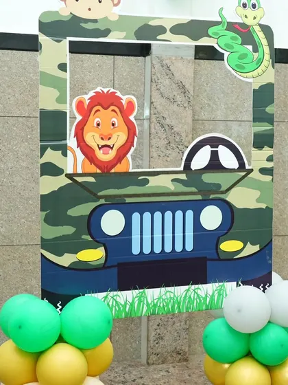 A fun photo-op frame for a jungle-themed party. Guests can pose with a lion and monkey in this custom jeep-themed photo booth prop.