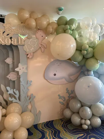 A close-up of the "Under the Sea" backdrop, showing the cute whale and turtle cutouts amidst the balloon bubbles.