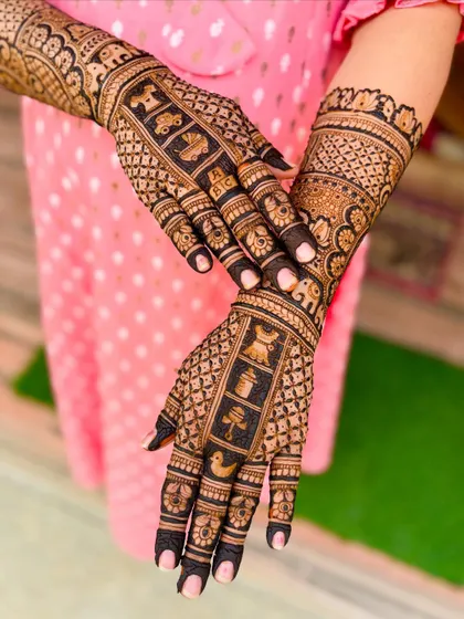 A posed shot showing the beautiful contrast and detail in this mother-daughter baby shower mehendi set.