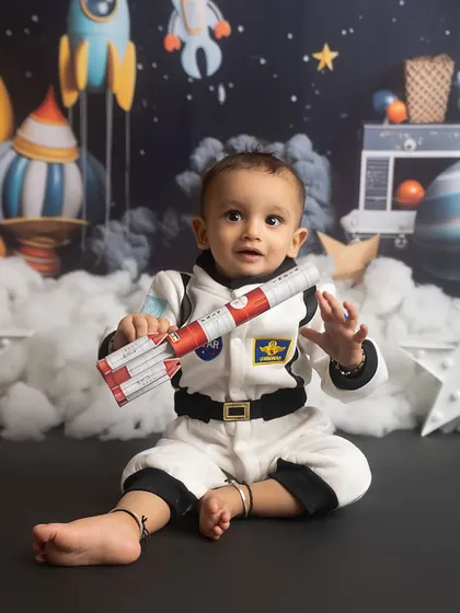 One small step for a baby, one giant leap for cuteness! This little astronaut is ready for his space mission in our out-of-this-world themed setup.