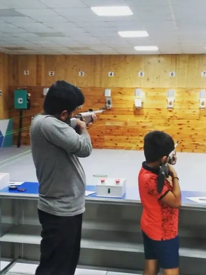 A group of shooters, including a young boy, learning the fundamentals of air rifle shooting. We ensure a safe and supervised environment for all ages.