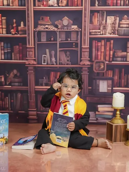 Deep in study, this little wizard is examining his book. The details, like the candle props, add to the magical ambiance.