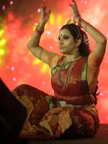 A seated pose capturing the expressive nature of the performance. The eye makeup, with its classic winged liner and defined brows, is central to conveying the character's emotions.