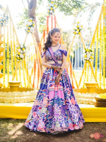 A beautiful portrait of the bride, Nelya, against the stunning yellow decor of her Haldi ceremony.