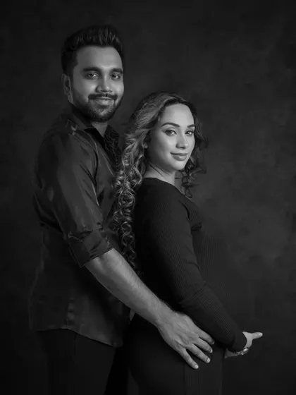 A classic and strong black and white portrait. The couple looks confidently at the camera, the side lighting beautifully sculpting their features and creating a dramatic and elegant image.