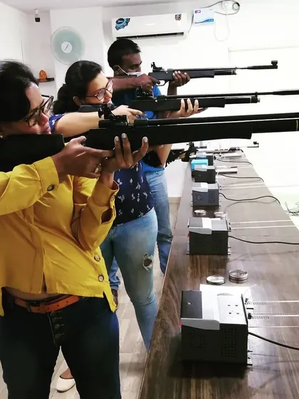 A shooter takes careful aim with her air rifle. Each station is equipped with its own electronic target system for a seamless shooting experience.