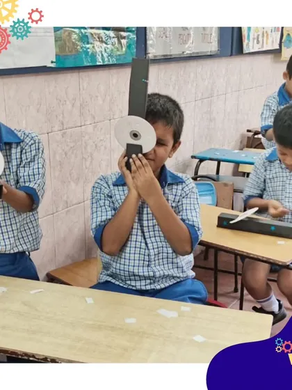 A student peers through his DIY spectroscope, discovering the spectrum of light. These take-home projects allow the learning to continue long after the class ends.