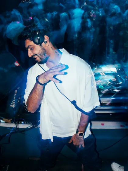 A motion-blur photo from Club Illusions that captures the feeling of being lost in the rhythm. The blue streaks of light add to the dynamic energy.