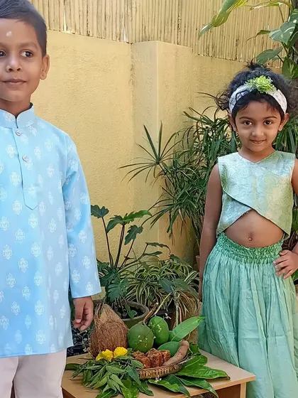Two children posing by the traditional Ugadi platter.