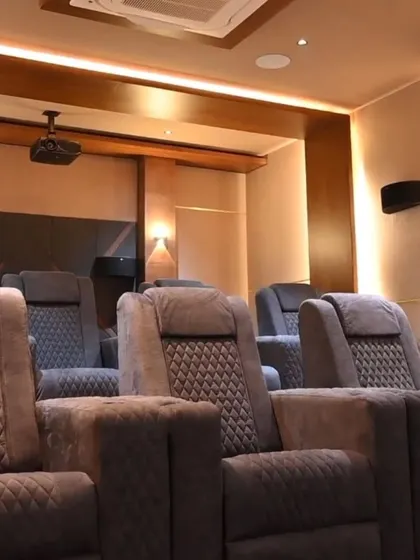 The plush, quilted recliners in this home theater are not just comfortable, they are also smart. Each seat can be adjusted electronically for the perfect viewing angle.