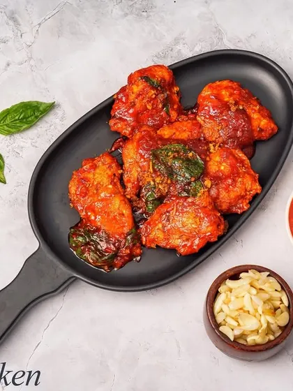 Our Thai Chicken appetizer is packed with authentic flavors. Tender chicken pieces are cooked in a rich, spicy red sauce with hints of Thai herbs, served with a side of dipping sauce and fresh garlic.