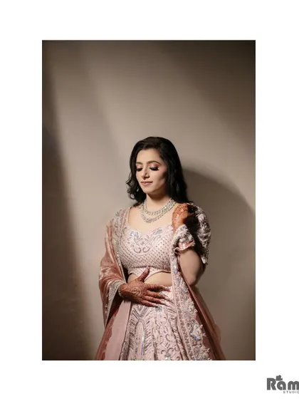 A simple and elegant portrait of the bride, looking down with a gentle smile. The soft lighting creates a serene and graceful mood.