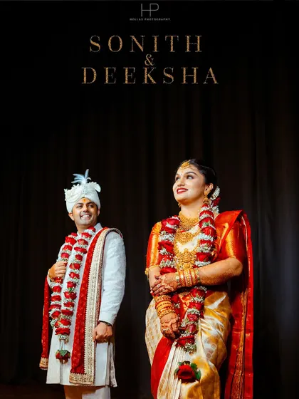 A stunning, dramatic portrait of the bride and groom in their wedding attire against a dark backdrop.