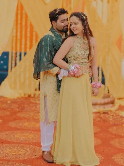 A sweet and romantic moment from a Haldi ceremony, with the couple sharing a gentle embrace.